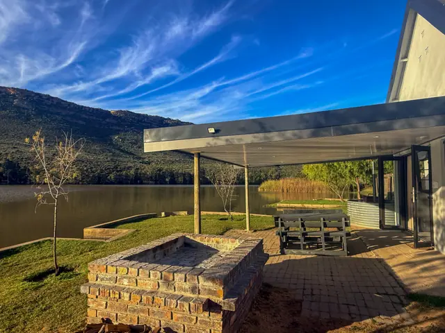 Built-in braai on the stoep, dam beyond