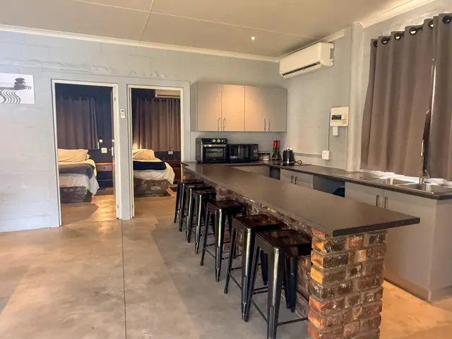 Kitchen, bar counter and the bedrooms beyond